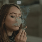 lady smoking a lit preroll